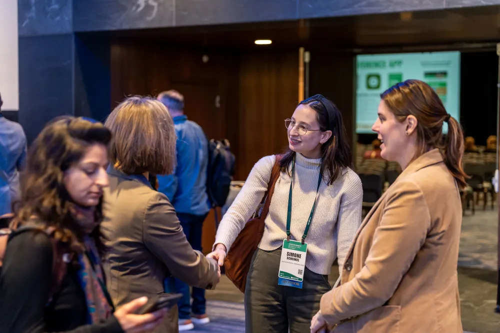 Agricultural Alliance members talking at a conference. 