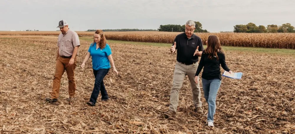 Farmers walking through their pasture. 