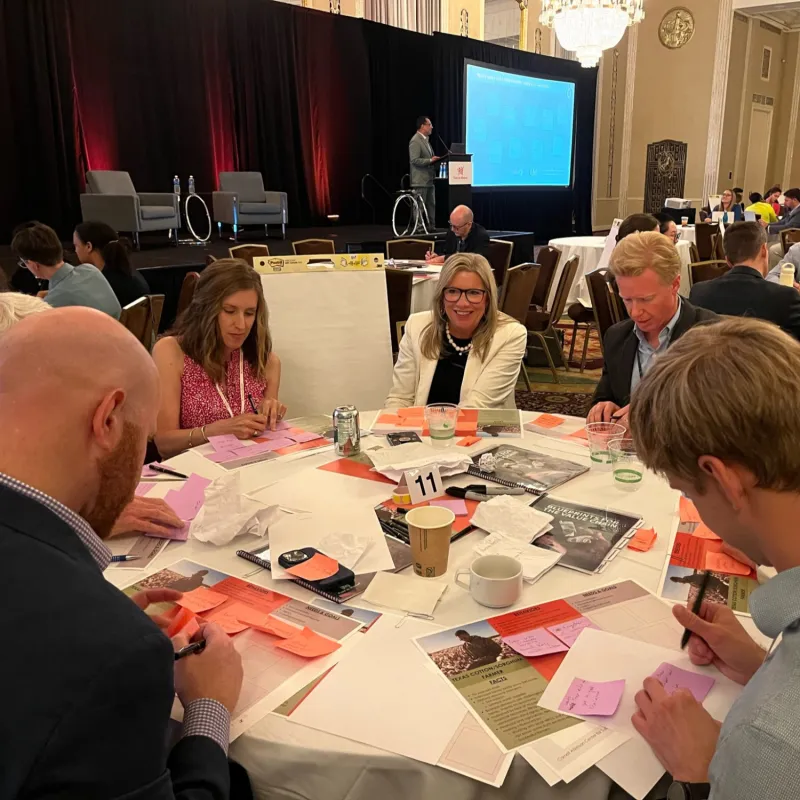 Attendees at a conference table 