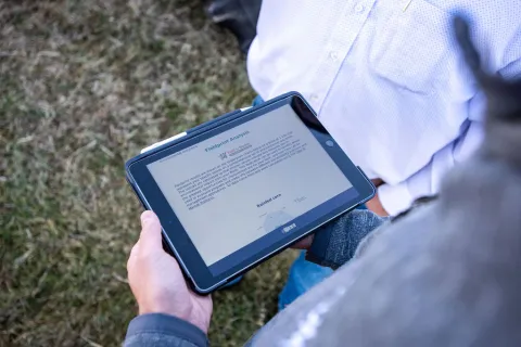 Farmer viewing a tablet. 