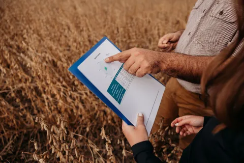 Farmer is reading a data report. 