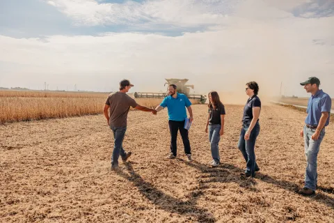 Farmers standing in a field. 