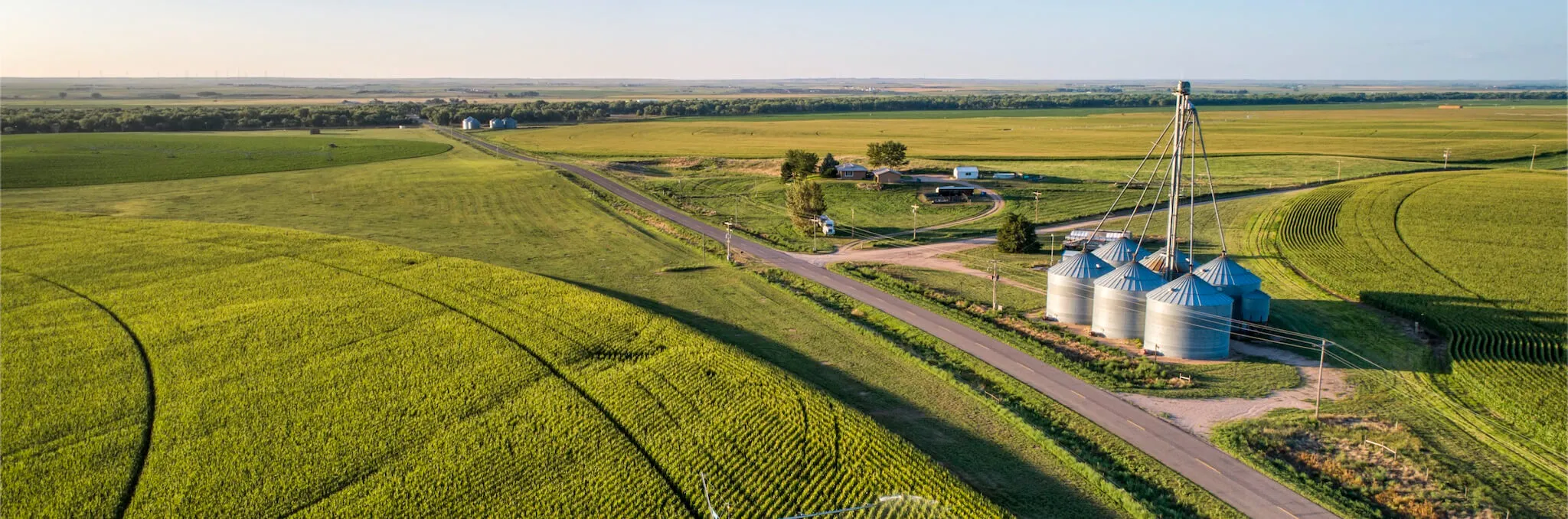 An aerial view of farmland and silos 